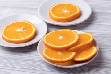 sliced fresh citruses and orange juice on the light rustic wooden surface. top view