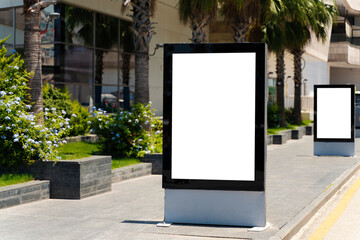 Street advertising mockup template with copy space. Two outdoor commercial banners with white empty display on the day street