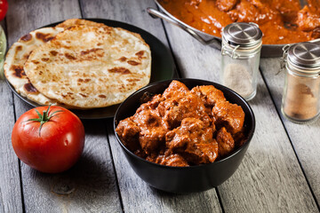 Chicken tikka masala served with bread naan