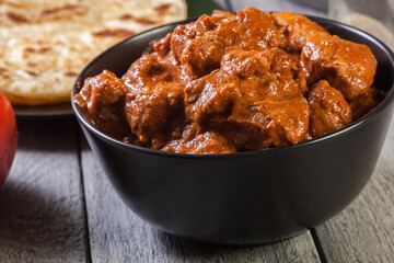 Chicken tikka masala served with bread naan