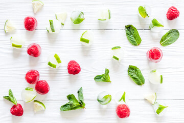Berries frozen in ice cubes background flat lay