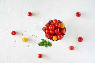 Pepper, cherry tomatoes yellow and red, spices on a white background. View from above. Copy space.