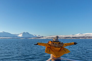 Girl in yellow enjoying fjord cruise