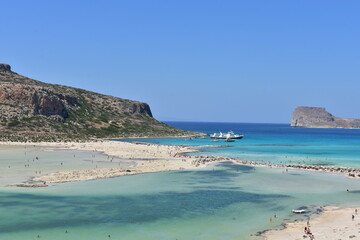 View of the beautiful Balos beach with azure water, white and pink sand on the island of Crete in Greece on a holiday day.
