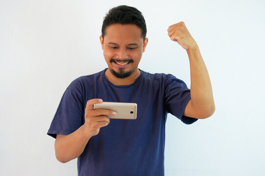 happy asian man holding phone in landscape moode