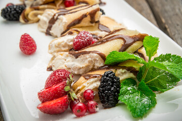 pancakes with cottage cheese in the middle and berry sauce