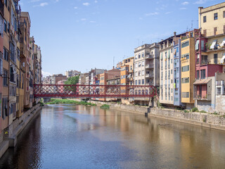 Girona City (Spain) view on red the Eiffel bridge over Onyar river