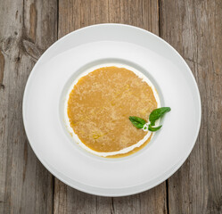 Curried carrot soup with cream and fresh herbs