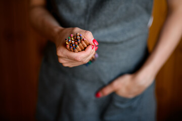 Closeup of bunch of colored pencils in woman's hand