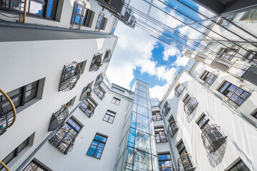 Modern buildings. Living houses with lots of forged iron balconies and windows