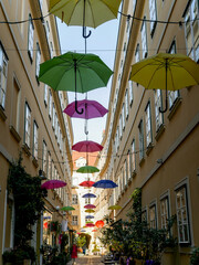 Fototapeta premium Narrow European street decorated with umbrellas