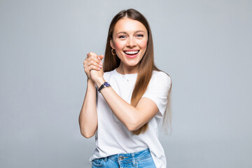 Young beautiful brunette woman clapping hands together over isolated white background