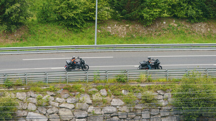 Country road in mountains. Two motorcyclists rides on highway. Ecological land of Bizkaia (Basque...