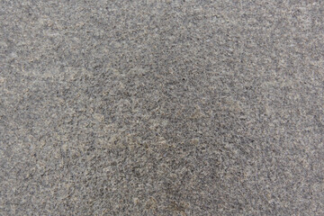 The texture of the stone close up. Street tile wet from the rain.