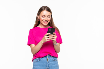 Fototapeta premium Smiling young girl text messaging on her mobile, isolated over white background