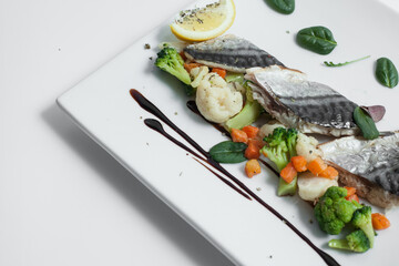 steam cooked mackerel fish with vegetables isolated