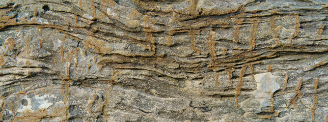 Photography of the rock texture. Detail of cliff in Zumaia in Basque Autonomous Community / country in summer cloudy day in Bay of Biscay. Ornamental pattern of mountain surface. High resolution image