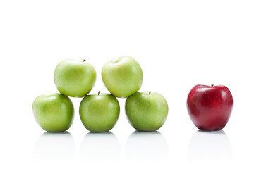 one red apple and many green isolated on white background 