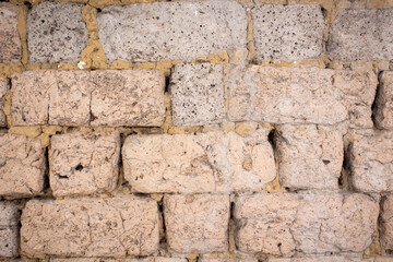Fototapeta premium Old wall of clay blocks. Background of clay brickwork.