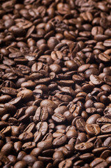 Roasted coffee beans background - full frame detail. Close up of a brown surface texture of aroma black caffeine drink ingredient for coffee beverage