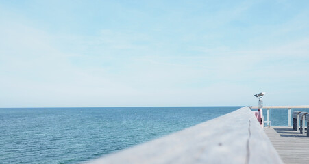 Binoculars on a pier, concept for far-sightedness or look into the future