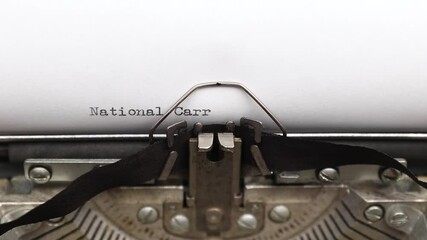 Typing a phrase National Carrot Cake Day on a vintage typewriter close-up. concept of festive banner for national holiday