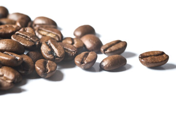 Roasted coffee beans isolated on white background - detail. Close up of a brown bean of aroma black caffeine drink ingredient for coffee beverage.