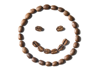 Smile face emoticon shape made of roasted coffee beans isolated on white background. Close up of a brown bean of aroma black caffeine drink ingredient for coffee beverage.