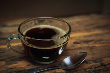 A black coffee cup on a wooden table