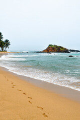 Tropical island footprints in the sand Sri Lanka