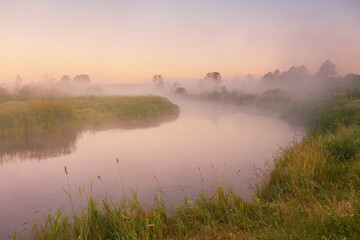 Fototapeta na wymiar Morning fog on river. Beautiful summer sunrise landscape