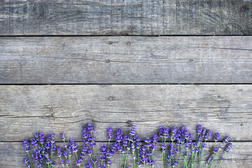 Lavender twigs on old wooden background, rustic wood table with lavender, banner copy space