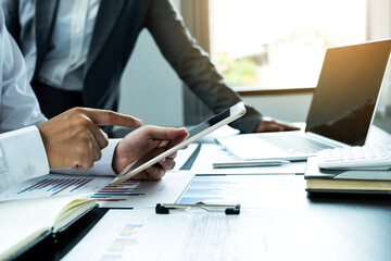 businessmen and businesswomen team meeting to plan strategies to increase business income. Have a brainstorming graph analysis and discussing for the new target success