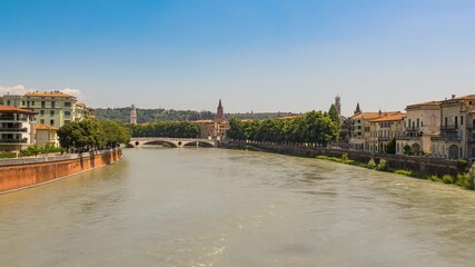 Fototapeta na wymiar View of the Adige river and Ponte della Vittoria (Bridge of Victory). Verona Italy