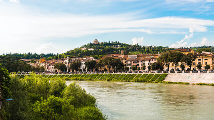 Fototapeta na wymiar View over Adige river on church Sanctuary of the Madonna of Lourdes, Santuario della Madonna di Lourdes. Verona, Italy 