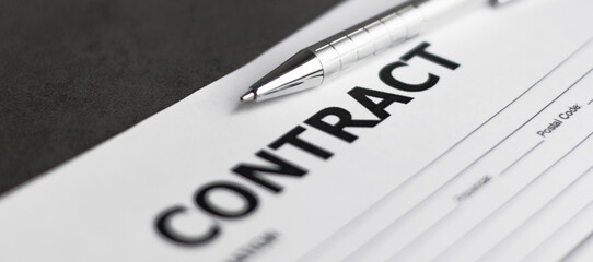 Business Contract and pen close up on grey background