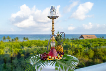 Tropical flavored hookah with jungle and sea background