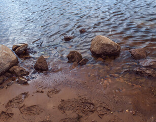 On the banks of the city river in the evening before the rain