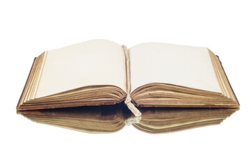 An old vintage open book reflecting on a white surface