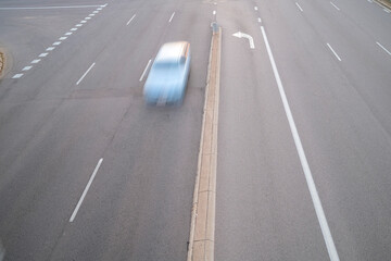 High angle view of a car zooming on a road