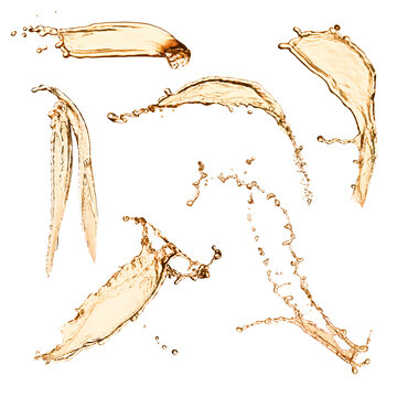 Set with abstract splashes of expensive whiskey on white background