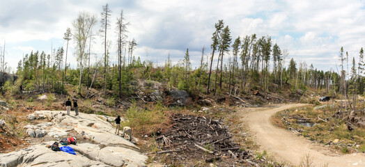 SUDBURY, ONTARIO, CANADA - MAY 23 2009: Group of workers and geologists standing and working on geological outcrop site. - 361756308