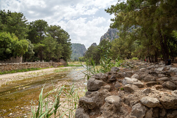 Ruins of the ancient city of Olympos in Cirali village in Antalya, Turkey.  Local and foreign tourists come to visit the ancient city and swim.