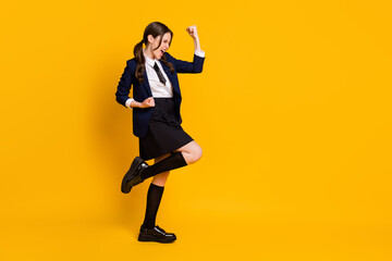 Fototapeta na wymiar Full size photo of crazy delighted successful teen girl raise fists scream enjoy rejoice academic courses exam pass wear blazer shoes isolated over bright shine color background