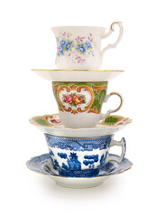 Stack of a variety of teacups on a completely white background. Contains clipping path.