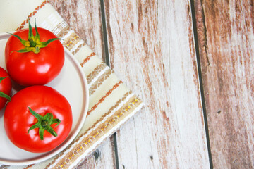 natural red tomato fruit on a decorative plate