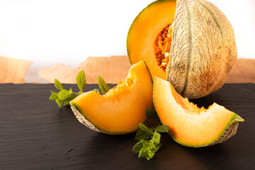 Summer food concept Melon fruit on black slate board with copy space