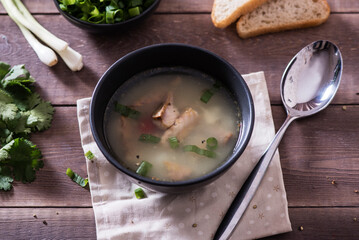 Fresh fish soup with ingredients and spices for cooking. Woodn background
