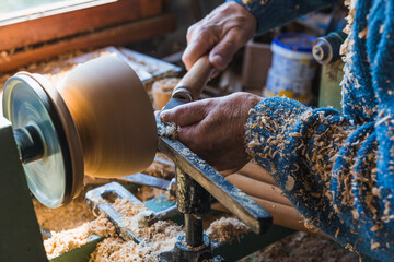 Skilled carpenter working the wood with a chisel. Close up.