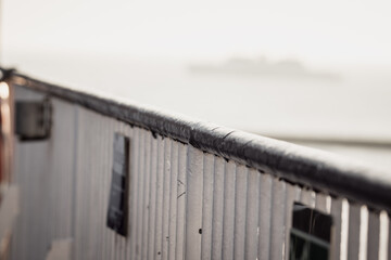 Ship railing on the ferry at sunset